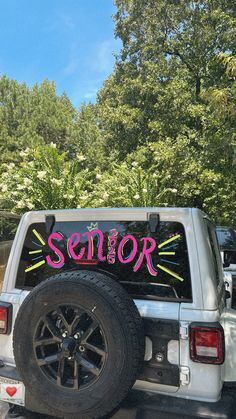 a white truck with the word senior painted on it's back window and tire