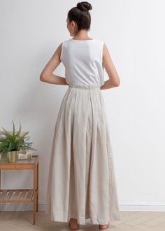 Beige Long Skirt With Buttons, Beige Buttoned Long Skirt, White Linen Lined Skirt, Beige Linen Maxi Skirt For Spring, Beige Linen Bottoms With Buttons, Spring Linen Skirted Bottoms, Flowy Linen Pleated Skirt, Linen Pleated Long Skirt, White Pleated Linen Skirt