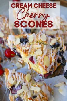 a white plate topped with blueberry cream cheese scones