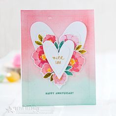 a heart shaped card with flowers on it