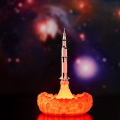 an orange rocket is shown in front of a space background