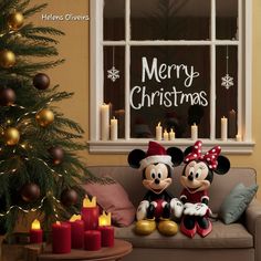 two mickey and minnie mouses sitting on a couch in front of a christmas tree