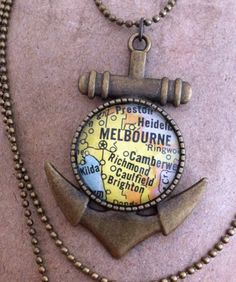 a necklace with an anchor and map on it