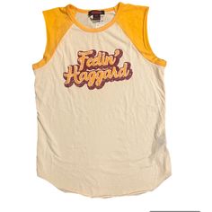 Feeling Haggard Graphic Tee From Cavender’s. Retro Crew Neck Tank Top For Summer, Retro Cotton Muscle Tee Sleeveless, Yellow Tank Top With Graphic Print For Spring, Retro Sleeveless Muscle Tee In Cotton, Retro Cotton Sleeveless Muscle Tee, Yellow Graphic Print Tank Top For Spring, Spring Yellow Tank Top With Graphic Print, Retro Yellow Tank Top For Spring, Vintage Cotton Muscle Tee For Spring