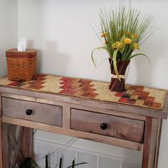 a wooden table with two drawers and flowers on top