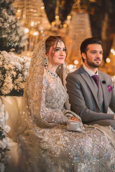 the bride and groom are sitting together