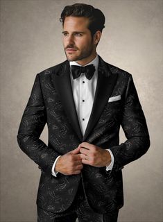 On the hunt for a blazer that seamlessly combines versatility with undeniable style? Meet our Italian Caprino Tuxedo Blazer! Crafted from pure poly fabric, its sleek black hue and the intricate paisley design in silver infuse it with personality, adding a touch of luxury to any ensemble. Whether you're stepping out to a fancy soirée or just want to elevate your everyday look, this versatile piece has got you covered in both flair and functionality.  An elusive unique piece from our Red Carpet Collection.   Look features a 2 button tuxedo jacket with black cherry satin wide peak lapel, matching satin covered buttons, single vent and three cuff buttons.  Click 'Customize Now' to modify the look if needed.  Jacket is fully lined.  Lining: Viscose.     We have sourced stocks from the finest re Luxury Silk Tuxedo With Single Button, Luxury Semi-formal Tuxedo In Suiting Fabric, Luxury Embellished Tuxedo For Semi-formal Occasions, Luxury Single-button Evening Tuxedo, Luxury Embroidered Semi-formal Tuxedo, Master Tailor, Pattern Weights, Tuxedo Blazer, Peak Lapel