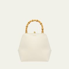 Jil Sander "Goji" top handle bag in calf leather  Bamboo top handle  Structured top with kiss-lock closure  Approx. 5.5"H x 5.1"W x 2"D Made in Italy White Leather Shoulder Bag With Bamboo Handle, Evening Leather Shoulder Bag With Bamboo Handle, Leather Shoulder Bag With Bamboo Handle For Evening, White Top Handle Bag With Bamboo Details, Classic Evening Shoulder Bag With Bamboo Handle, Formal Shoulder Bag With Bamboo Handle, Elegant White Bag With Bamboo Handle, Elegant Tote Bag With Bamboo Handle, Luxury Formal Satchel With Bamboo Handle