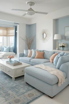 a living room with blue couches and white coffee table in front of a window