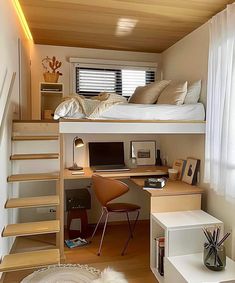 there is a loft bed with stairs to the top and desk below it in this small room