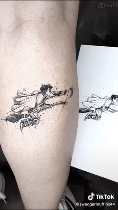 a man's leg with a tattoo on it that has a drawing of a person riding a skateboard