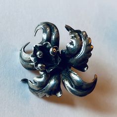 "This is a whimsical pair of vintage sterling silver (.925) floral/flower \"screw back/clip on\" earrings. Note: They do not have physical clips, but they are for non-pierced ears. The backs screw until the earring is secure in place against one's earlobe. Material(s): sterling silver (.925) Total weight 7.2 grams Flaws (if any): None to mention Marking(s): \"925\" (translating to \"sterling silver) Measurements: These earrings measure one inch in height and one inch in width. If you have any qu Vintage Sterling Silver Clip-on Earrings, Vintage Flower Shaped Clip-on Earrings, Vintage Silver Handmade Flower Earrings, Vintage Handmade Silver Flower Earrings, Vintage Flower Shaped Earrings For Anniversary, Silver Vintage Flower Earrings For Anniversary, Silver Vintage Flower Earrings For Formal Occasions, Vintage Clip-on Flower Earrings, Vintage Silver Flower-shaped Earrings