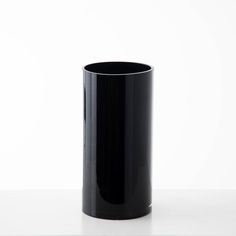 a black vase sitting on top of a table