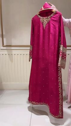 Meticulously crafted from a remarkably glamourous shade of fuchsia ( pure raw silk ) with its intricate hand crafted details strikes the perfect balance between elegant and eye-catching, making this beautiful design a must have. Shop on www.aghanoorbridal.com Raw Silk Dress Pakistani Party Wear, Wedding Wear Dresses For Women, Raw Silk Suit Designs Indian, Raw Silk Dress Designs, Pakistani Party Wear Suits, Pink Dress Ideas, Embroidered Dress Formal, Agha Noor Dresses