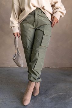 #html-body [data-pb-style=Q1VWAPJ]{justify-content:flex-start;display:flex;flex-direction:column;background-position:left top;background-size:cover;background-repeat:no-repeat;background-attachment:scroll} The Cleo Olive Parachute Cargo Pants feature olive green lightweight fabric with a matte finish, a front zipper with a button closure, belt loops, an elastic back band, two front slip pockets, four side cargo pockets, two back cargo pockets, stitched details, and relaxed legs with elastic ankl Wide Leg Cargo Pants Outfit, Parachute Cargo Pants, Olive Green Cargo Pants, Parachute Cargo, Pants Gift, Style Inspiration Casual, Cargo Pants Outfit, Winter Fit, Green Cargo Pants