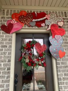 a wreath on the front door of a home decorated for valentine's day with hearts