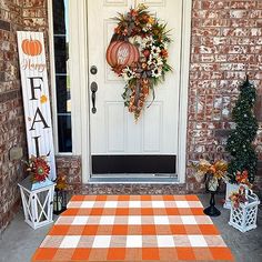 an orange and white checkered rug on the front porch