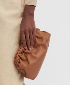 !!!Description---A Mansur Gavriel signature, our sculptural clutch is handcrafted from supple Italian lambskin, featuring an elegantly curved frame with a magnetic closure. Wear it as a clutch, shoulder, crossbody, or belt bag. !!!Fits---iPhone 14 Max and smaller !!!Details---Width: 9.5 in / 24 cmHeight: 5 in / 12.5 cmDepth: 2.75 in / 7 cmStrap drop: 21 in / 53 cm Composition: 100% Italian Lambskin LeatherMade in Italy!!!Materials--- Our Italian lambskin is an ultra-smooth, buttery leather. Lamb Chic Pouch Clutch With Leather Lining, Chic Leather-lined Pouch Clutch, Luxury Brown Soft Leather Clutch, Modern Brown Clutch With Dust Bag Included, Modern Brown Clutch With Dust Bag, Versatile Beige Leather Clutch, Brown Clutch With Dust Bag, Chic Leather Clutch With Smooth Grain, Elegant Brown Clutch With Smooth Grain