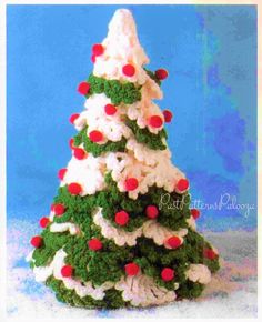 a christmas tree made out of crochet and yarn with red berries on it