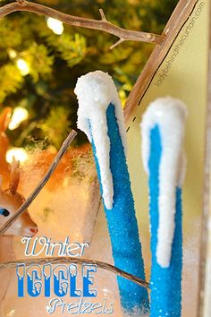 two toothbrushes sitting on top of a counter next to a fake deer head