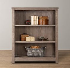 an old bookcase with books and baskets on it