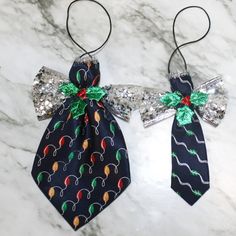 two ties with bows on them sitting on a marble surface