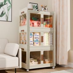 a living room with a white chair and bookcase