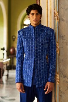 Blue bandhgala featuring thread embroidered geometric motifs highlighted by tonal crystal and bead embellishments. Comes with straight pant. - Aza Fashions Fitted Hand Embellished Kurta For Eid, Traditional Hand Embellished Blue Set, Fitted Hand Embellished Kurta For Festivals, Fitted Blue Bandhgala With Intricate Embroidery, Fitted Blue Kurta With Motifs, Blue Fitted Kurta With Motifs, Designer Motif Fitted Sets, Designer Fitted Sets With Motifs, Designer Fitted Kurta With Motifs