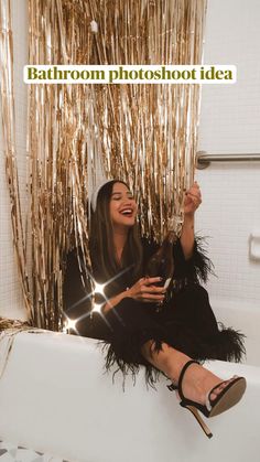 a woman sitting in a bathtub laughing and holding a wine glass with the words bathroom photoshoot idea