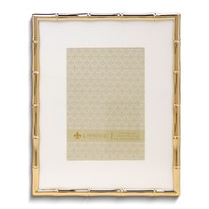 a white and gold frame with an ornate pattern on the bottom, in front of a white background