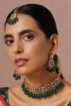 Gold finish floral shaped choker with green kundan embellishment. Comes with earrings and maangtikka.
Component: 1 Choker, Pair Of Earrings, Maangtikka
Type: Kundan
Composition: Brass
Color: Green
Other Details: 
Pearl drops
Dimensions L x W (in inches):
Necklace: 14 x 13
Earrings: 2 x 1
Weight (in gms): 310
Closure:
Necklace: Pull out-drawcord
Earrings: Push back clasp
Maangtikka: Fish hook
 - Aza Fashions Indian Choker Necklace, Kundan Jewellery Bridal, Gray Necklace, Bridal Choker, Green Accessories, Color Necklace, Metal Necklace, Choker Set, Green Jewelry