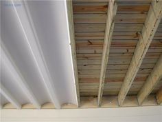 an unfinished ceiling with wood planks and white paint