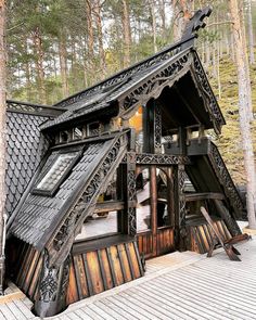 an unusual house built into the side of a forest