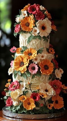 a multi - tiered cake decorated with flowers on a table