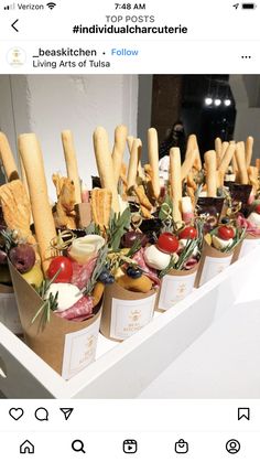 an appetizer is displayed on the table with food in cups and garnishes