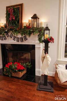 a fireplace decorated for christmas with stockings and poinsettis