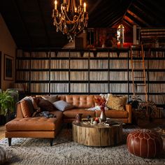 a living room filled with furniture and a chandelier