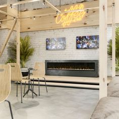 a living room filled with furniture and a fire place next to a wall mounted tv