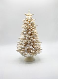 a white christmas tree made out of seashells