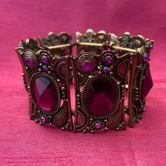 "This vintage brass and amethyst glass bracelet has an oriental flair. It consists of 7 elements strung together by strong rubber stretch bands. It is expandable.  Dimensions Approx. 2.36\" (6 cm) diameter x 1.57\" (4 cm) H. The width of each individual element is approx. 2\" (5 cm). The bracelet is in very good used condition." Vintage Purple Bangle Jewelry, Antique Adjustable Bracelets With Jewels, Handmade Bohemian Purple Bangle, Vintage Metal Stretch Bracelet For Gift, Adjustable Bohemian Bracelet With Antique Finish, Bohemian Jeweled Purple Jewelry, Antique Jeweled Metal Bracelets, Bohemian Metal Bracelets With Jewels, Vintage Purple Jewelry For Festival