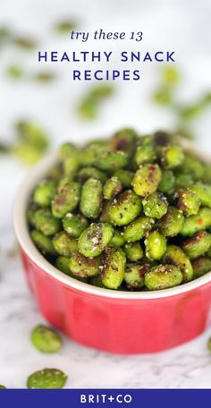 a red bowl filled with brussel sprouts on top of a table