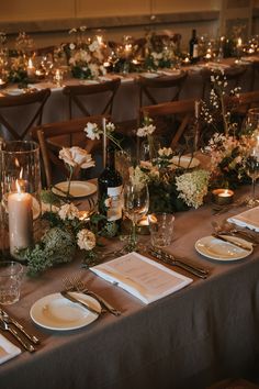 a table set with place settings, candles and napkins for an elegant wedding reception