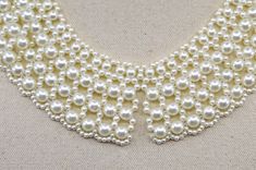 a white necklace with pearls on it