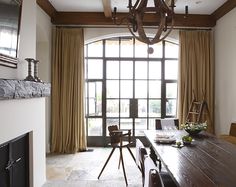 a dining room table and chairs in front of a large window