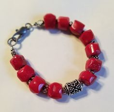 Chunky red bamboo coral and silver plated pewter. Lobster clasp. Elegant Red Coral Beaded Bracelets With Adjustable Fit, Adjustable Red Coral Bracelets, Handmade Elegant Red Coral Bracelets, Elegant Handmade Red Coral Bracelets, Elegant Red Coral Adjustable Bracelet, Elegant Adjustable Red Coral Bracelet, Red Bamboo, Bamboo Coral, Coral Bracelet