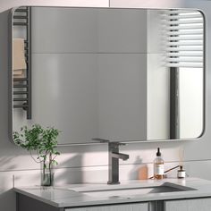 a bathroom sink sitting under a large mirror next to a wall mounted faucet