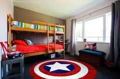 a bedroom with two bunk beds and a colorful rug in front of the bed area