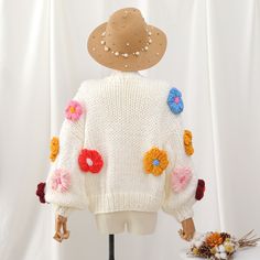 Thick chunky knit cropped cardigan with colorful puffy crochet flower pom poms all over. You're a cozy rainbow garden in this cute number. Each sweater weighs about 900g / 2lbs. 100% acrylic knit 24" across shoulders, 44" chest, 16-17" length Spring Cozy Sweater In Acrylic Yarn, Cozy Acrylic Yarn Sweater For Spring, Playful Spring Knitted Sweater, Playful Knitted Spring Sweater, Playful Knitted Sweater For Spring, White Acrylic Cardigan For Spring, Cute Chunky Knit Sweater For Spring, Spring Crochet Acrylic Sweater, Spring Acrylic Crochet Sweater