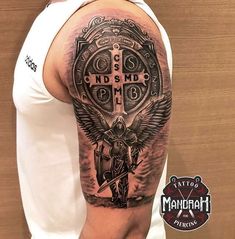 a man with a cross and wings tattoo on his arm