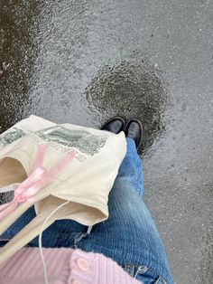 a person sitting in the rain with an umbrella